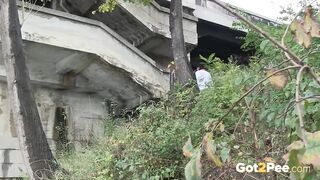 Raven Haired Girl Pees near the River