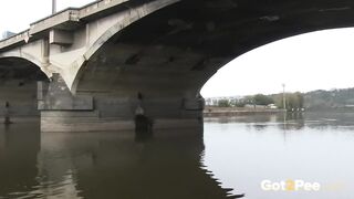 Raven Haired Girl Pees near the River