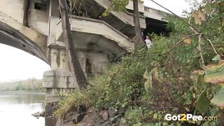 Raven Haired Girl Pees near the River