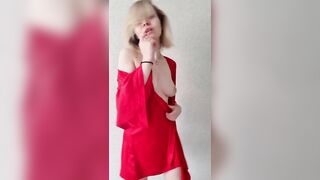 A beauty in a red robe shows her sweet ass.