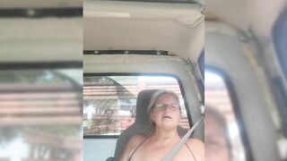 Blonde milf riding around with her tits out