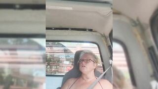 Blonde milf riding around with her tits out