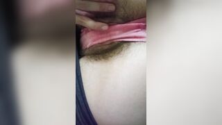 Tease in pink panties, hairy pussy lips.