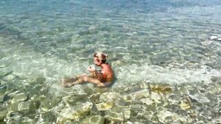 Slender tanned blonde gets fucked on the beach by the sound of waves during a photo shoot