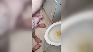 Teacher and student morning pee. Teacher helps student