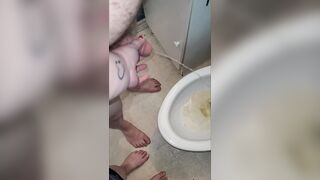 Teacher and student morning pee. Teacher helps student