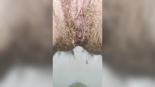 Hairy milf peeing in the toilet