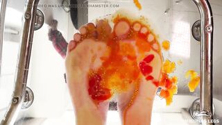 Squeezing cherry tomatoes with bare feet POV on your face